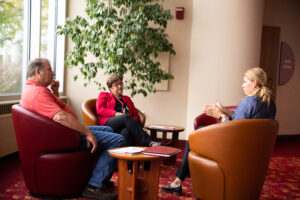 people conversing on comfy chairs