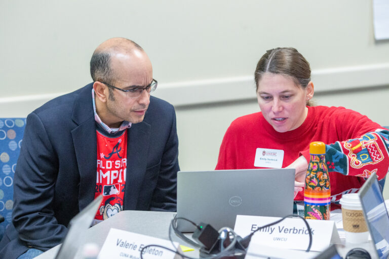 people working on a computer together