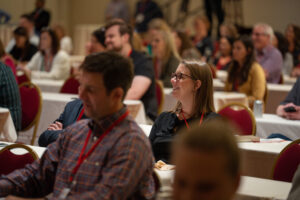 people in a room listening to a speaker